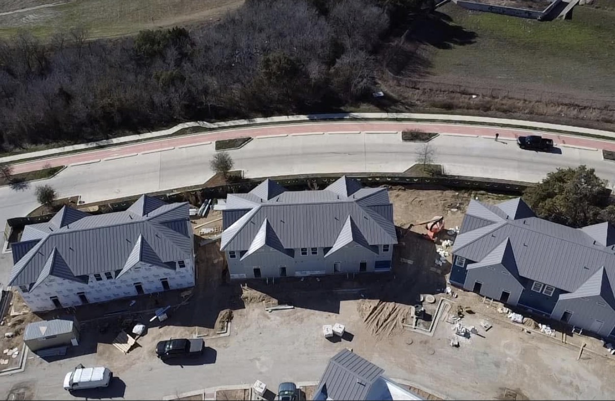 Standing seam metal roofing across multifamily buildings